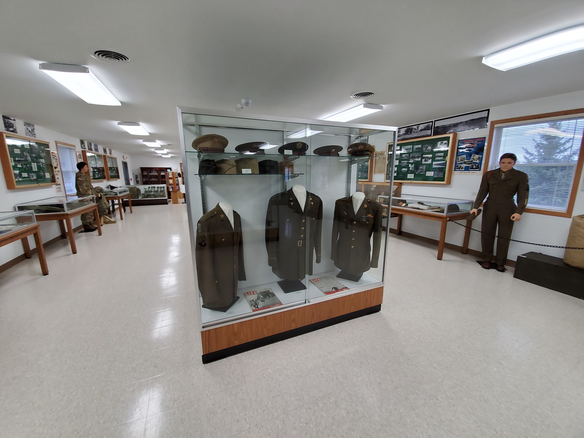 A room inside Fort McCoy's Historical Center featuring museum artifacts of US Army uniforms.